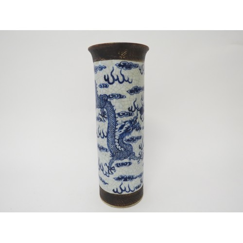 6031 - An early 20th Century Chinese cylindrical vase, dragons chasing the flaming pearl, cracked and resto... 