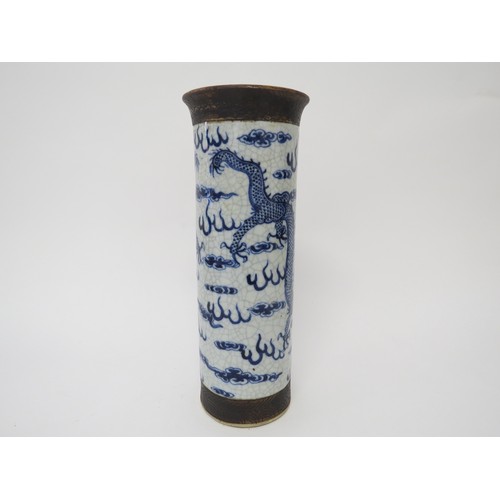 6031 - An early 20th Century Chinese cylindrical vase, dragons chasing the flaming pearl, cracked and resto... 