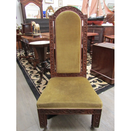 1352 - A late Victorian oak high back chair with highly ornate carving, velour upholstered back and seat