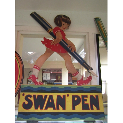 5529 - A plywood shop show piece depicting a girl holding a pen 'Swan Pen', 78cm tall