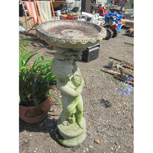 3632 - A composition bird bath of a boy holding a fish