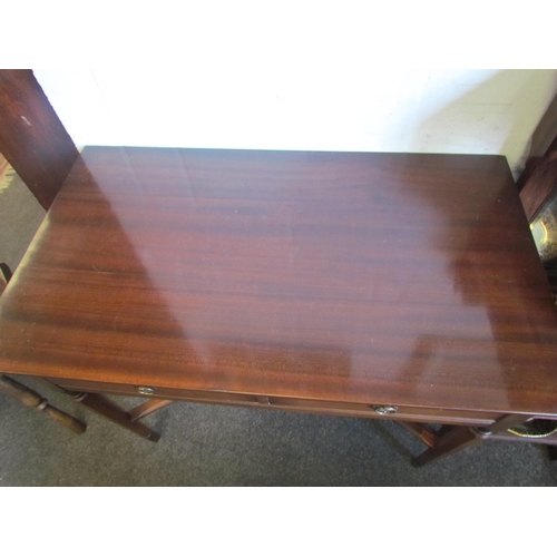 1221 - A mahogany two drawer writing table with red leather insert brushing slide on chamfered tapering leg... 