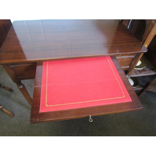 1221 - A mahogany two drawer writing table with red leather insert brushing slide on chamfered tapering leg... 