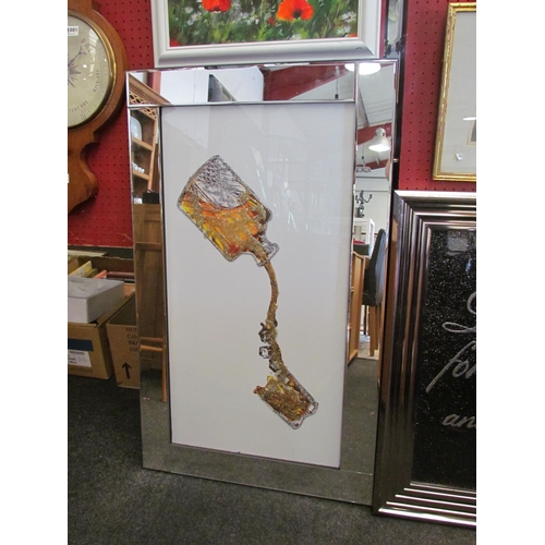 1264 - A mirror framed glitter image of spirit decanter pouring drink into glass, 84cm x 44cm image size