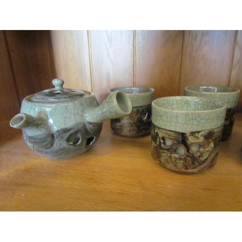 1283 - A Studio pottery tea set, crackle green glaze, pierced heart design