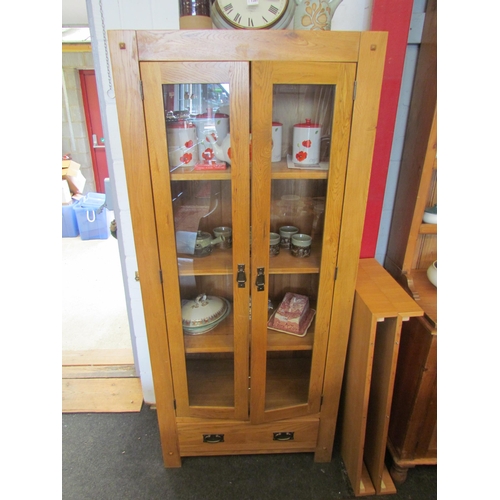 1285 - A modern oak two glazed door cupboard with single drawer, 180cm tall x 80cm wide x 40cm deep