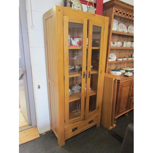 1285 - A modern oak two glazed door cupboard with single drawer, 180cm tall x 80cm wide x 40cm deep