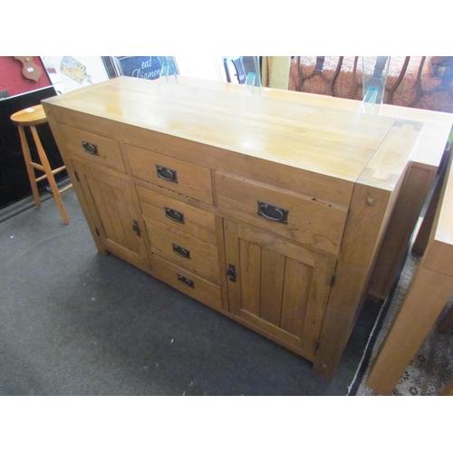 1293 - A modern oak six drawer, two cupboard door sideboard, 86cm tall x 139cm wide x 45cm deep