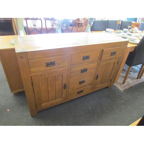 1293 - A modern oak six drawer, two cupboard door sideboard, 86cm tall x 139cm wide x 45cm deep