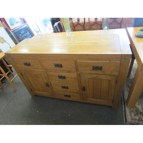 1293 - A modern oak six drawer, two cupboard door sideboard, 86cm tall x 139cm wide x 45cm deep