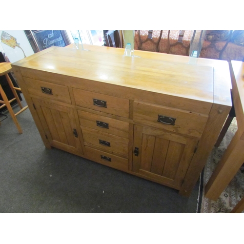 1293 - A modern oak six drawer, two cupboard door sideboard, 86cm tall x 139cm wide x 45cm deep