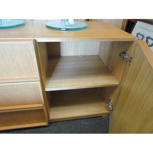 1296 - An oak veneer sideboard with three central drawers flanked by two cupboards, 73cm tall x 165cm wide ... 