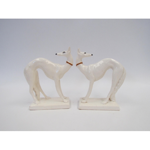 1587 - Two 1920's pottery models of Borzoi dogs, 14cm tall