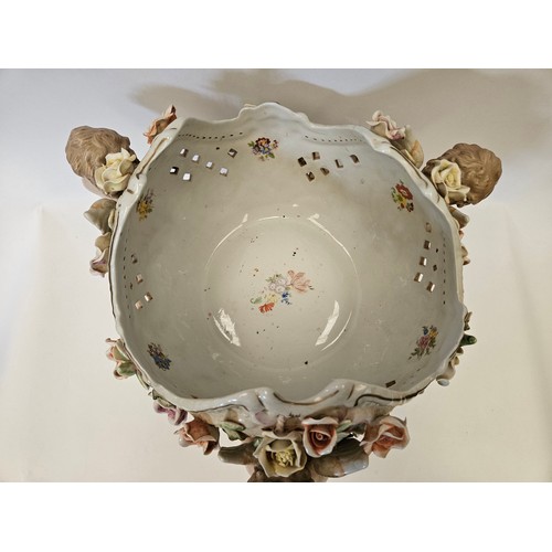 1382 - A modern Continental ceramic centrepiece bowl held aloft by three winged cherubs, applied flowers, c... 