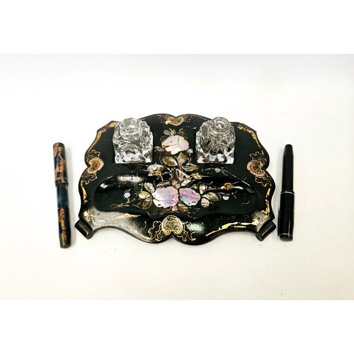 1385 - A papier-mache double ink stand inlaid with mother-of-pearl, glass ink bottles (minus tops) and two ... 