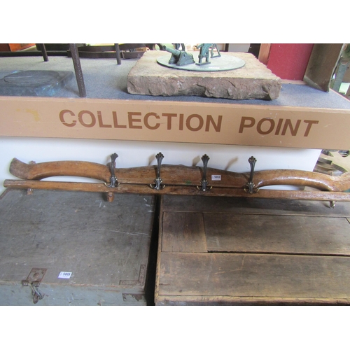 5003 - A wooden yoke with brass coat hooks attached  (R)  £30