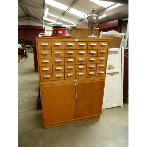 2058 - An oak serota multi-drawer chest on cupboard base