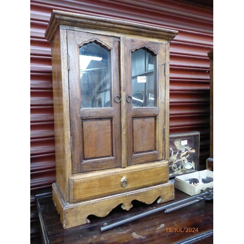 2110 - A pair of eastern hardwood bedside cabinets twin doors over single drawer