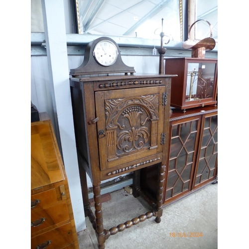 2136 - A 17th Century carved oak slim cupboard on bobbin turned legs