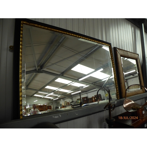 2137 - A black and gold framed mirror     (R) £15-20