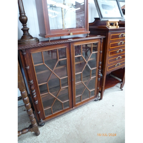 2141 - A Victorian mahogany astragal glazed bookcase, wrythen edge, spindle detail, on squashed bun feet