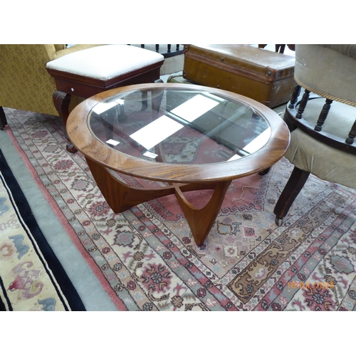 2354 - A mid Century G-Plan teak coffee table of circular form, glass insert