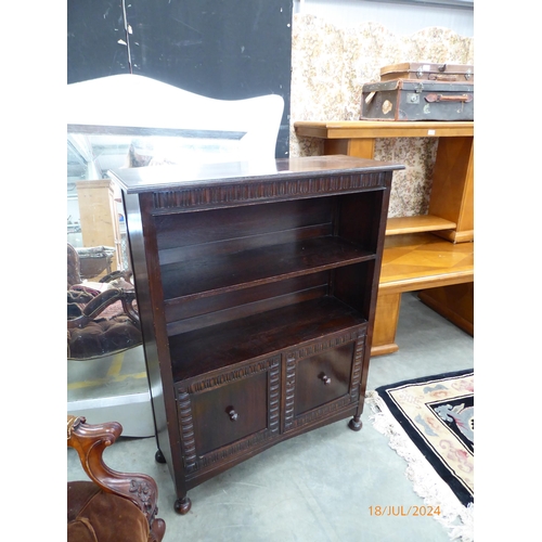 2367 - A modern Jacobean style oak bookcase with two door cabinet base