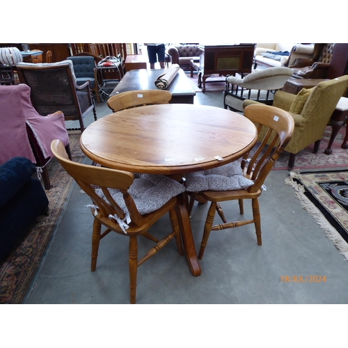 2378 - A country pine circular top kitchen table together with three lath back chairs (4)