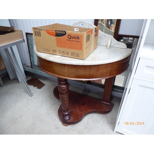 2402 - A Victorian mahogany demilune table, marble top, turned supports, with undertier