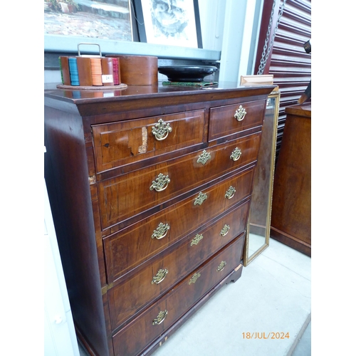 2414 - A Georgian walnut chest of two short over four long drawers, brass fretwork handles, satinwood bandi... 