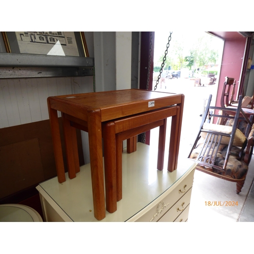 2474 - A mid century teak nest of three coffee tables, square supports