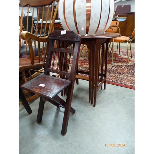 2486 - An elm seated child's folding chair together with a mahogany nest of three tables