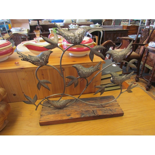 1311 - A pierced metal tealight holder of six birds in branches on wooden base, 45cm tall