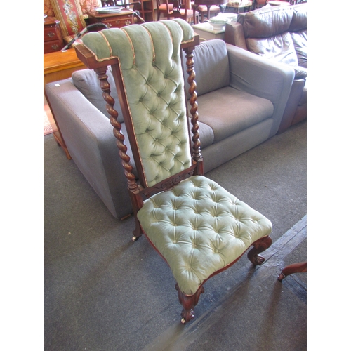 1343 - A figured walnut nursing chair, barley-twist supports, green velvet button-back and on cabriole legs... 