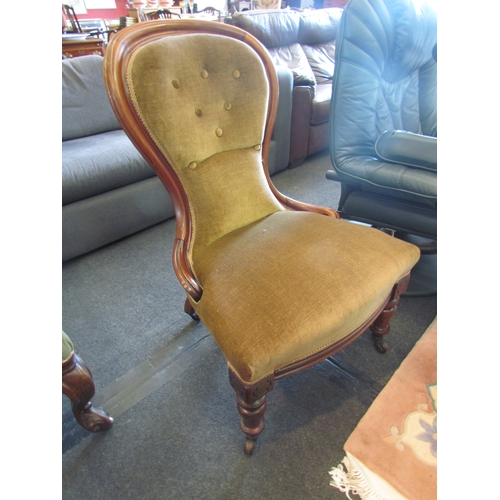 1344 - A circa 1860 mahogany spoon-back armchair with button backrest over turned fore legs and ceramic cas... 