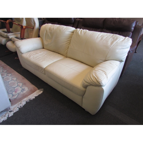 1348 - A cream leather two seater sofa