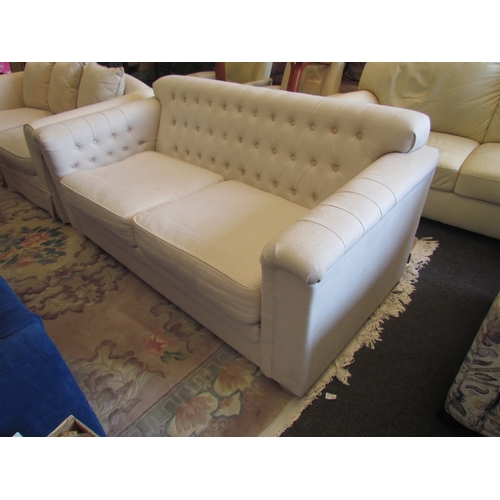 1350 - A Neptune two seater sofa, buttoned back, cream upholstery