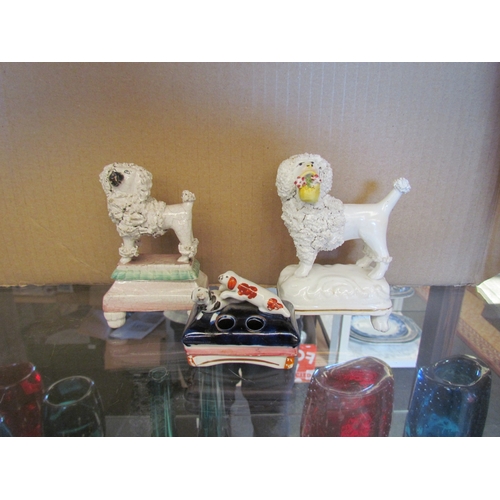 1614 - Three Victorian Staffordshire Dogs - two poodles and one spaniel quill holder