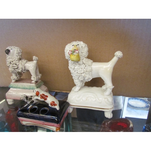 1614 - Three Victorian Staffordshire Dogs - two poodles and one spaniel quill holder