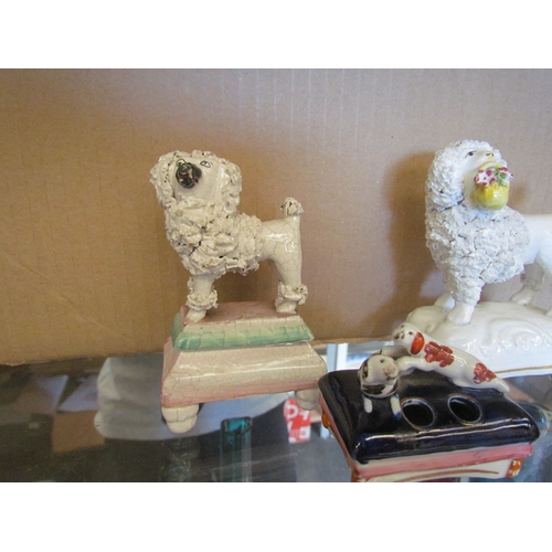 1614 - Three Victorian Staffordshire Dogs - two poodles and one spaniel quill holder