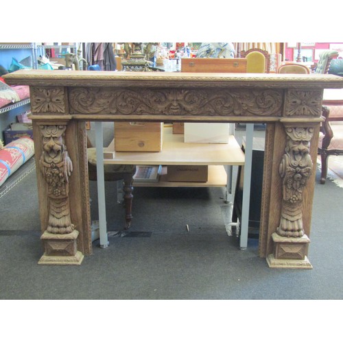 1018 - A carved oak fire surround, lavishly decorated with scrolling acanthus to the mantel and Asian-style... 