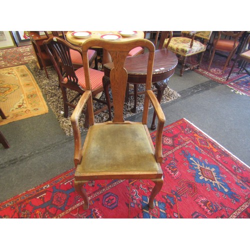 1001 - An oak armchair with vase-shaped back slat, cabriole fore legs to pad feet.