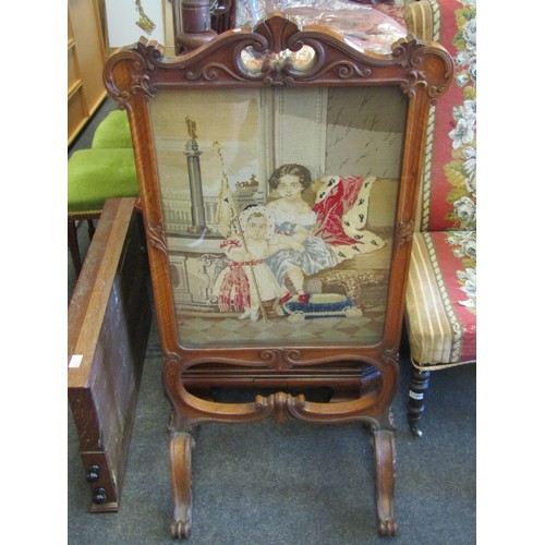 1007 - A Victorian walnut tapestry fire guard with image depicting two girls, in glazed, carved wooden fram... 