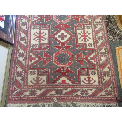 1236 - A Middle-Eastern rug, geometric patterns, tasseled fringe, 188cm x 107cm