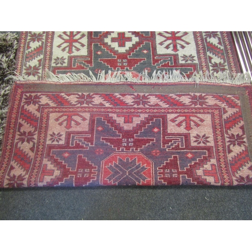 1236 - A Middle-Eastern rug, geometric patterns, tasseled fringe, 188cm x 107cm