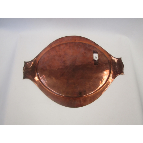 1659 - An Art Nouveau hammered copper dish with silver trim by A.E. Jones, Tudor rose roundels, 51cm long