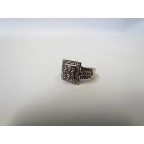 1037 - A 9ct white gold diamond-encrusted ring of stepped square form with diamond set shoulders. Size J/K,... 