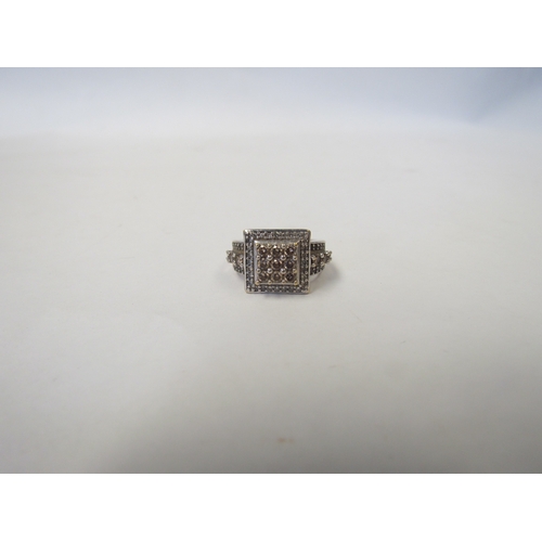 1037 - A 9ct white gold diamond-encrusted ring of stepped square form with diamond set shoulders. Size J/K,... 