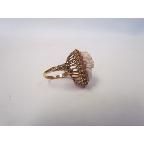 1039 - A cameo ring in high-profile mount, pierced basket and scroll shoulders, unmarked. Size Q, 9.8g