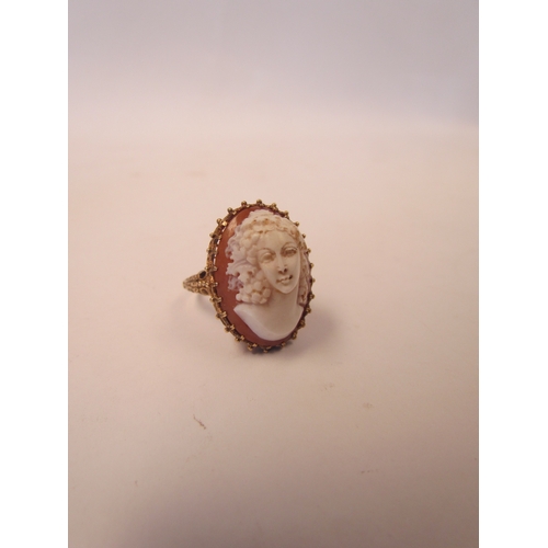 1039 - A cameo ring in high-profile mount, pierced basket and scroll shoulders, unmarked. Size Q, 9.8g